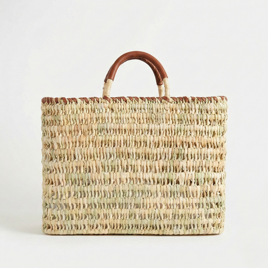 Woven handbag with brown handles on a white background