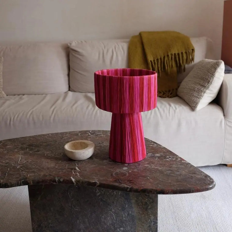 Living room with a red textured table and marble coffee table