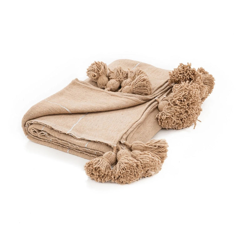 Beige blanket with pom-pom details on a white background
