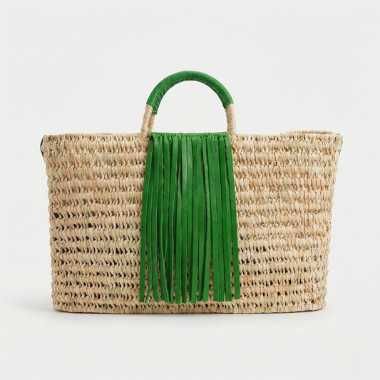 Woven bag with green fringe handle on a white background