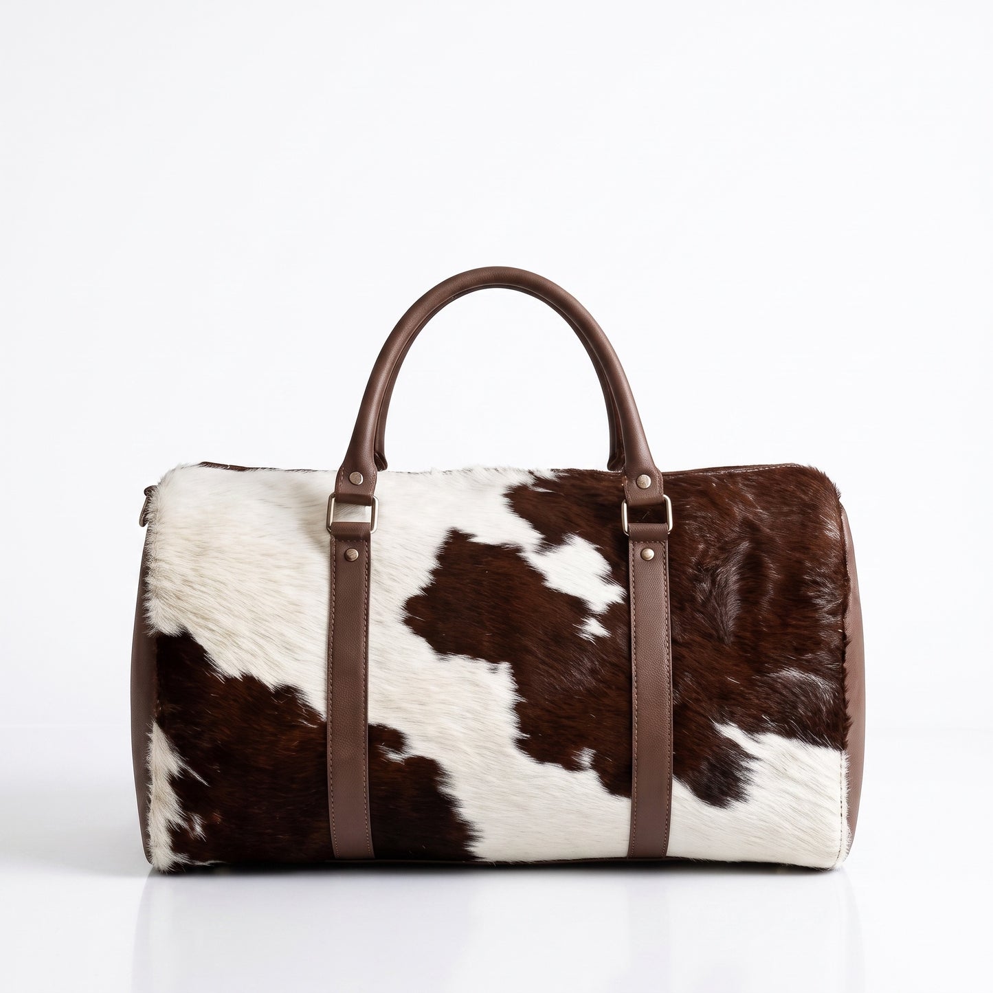 Handmade brown and white cowhide leather duffle bag with brown leather handles and silver hardware, Moroccan weekender travel bag from Marrakech