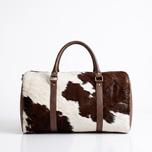 Handmade brown and white cowhide leather duffle bag with brown leather handles and silver hardware, Moroccan weekender travel bag from Marrakech