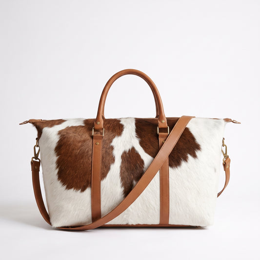 Handmade brown and white cowhide weekender bag with tan leather handles, antique brass hardware and detachable shoulder strap, Moroccan travel tote
