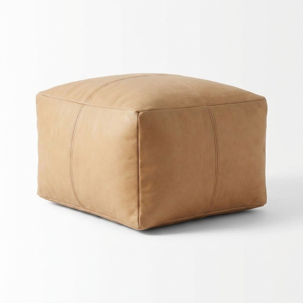 Tan leather ottoman on a white background