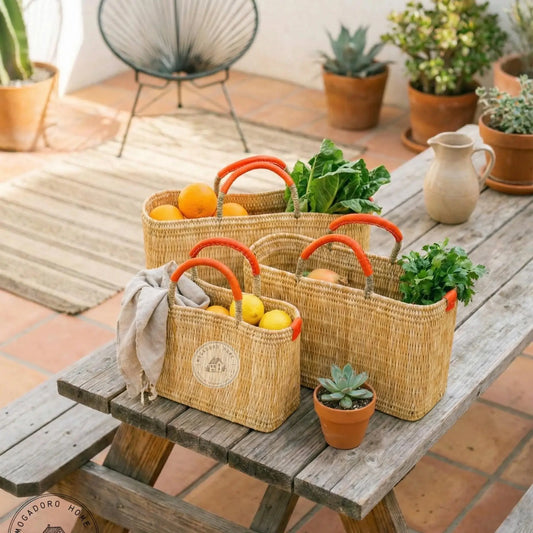 Wicker baskets with fresh produce on a wooden table outdoors